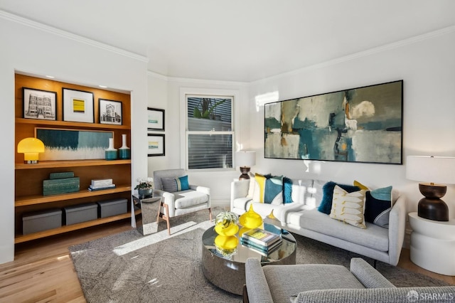 living room with light wood-type flooring and ornamental molding