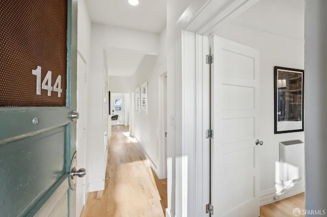 hall featuring light hardwood / wood-style floors and radiator