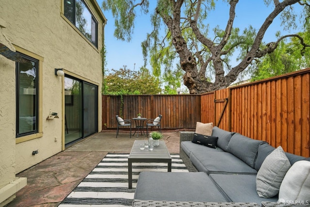 view of patio / terrace featuring an outdoor hangout area and a fenced backyard
