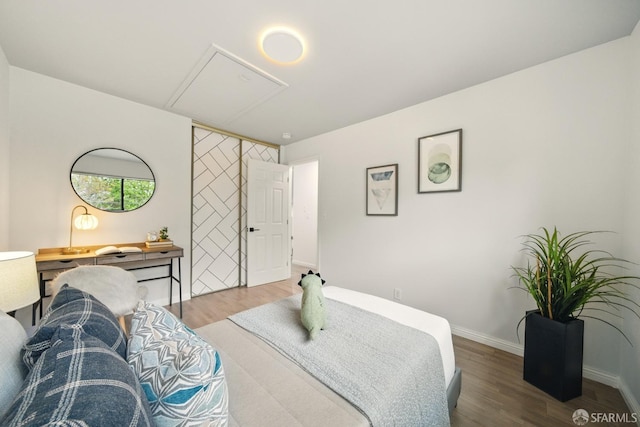 bedroom featuring baseboards and wood finished floors