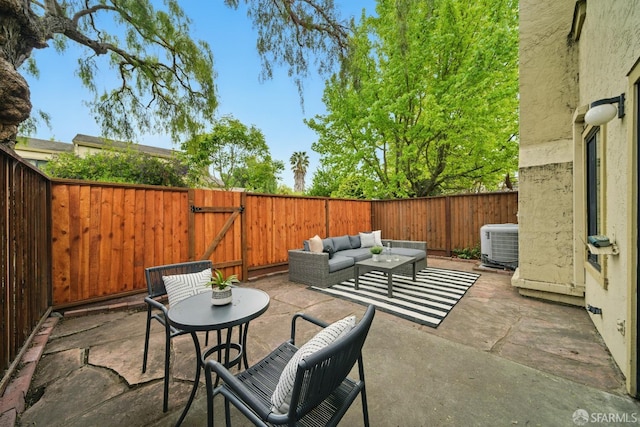 view of patio featuring a fenced backyard, a gate, an outdoor hangout area, and cooling unit