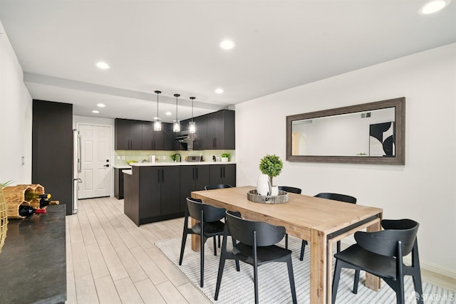 dining room with recessed lighting and light wood-style flooring