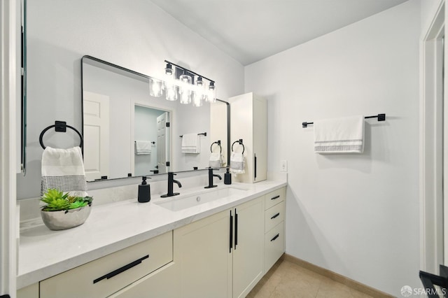 bathroom with vanity, baseboards, and tile patterned floors
