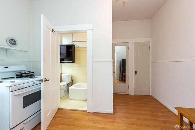 kitchen featuring white range and light hardwood / wood-style floors