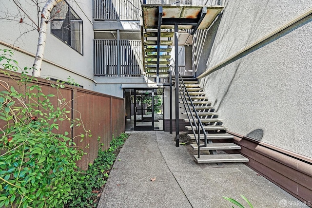 entrance to property featuring a patio and fence