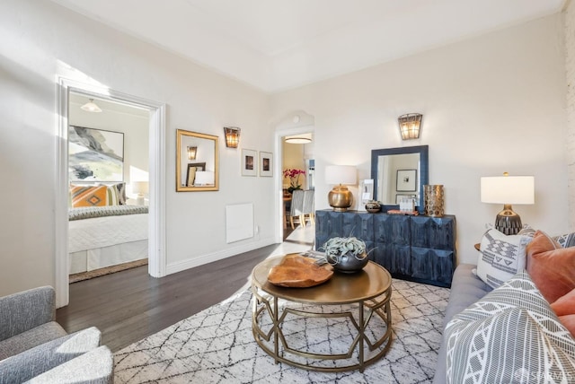 living area featuring baseboards and wood finished floors