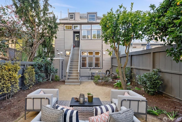 rear view of property with a patio, stairway, outdoor lounge area, and a fenced backyard