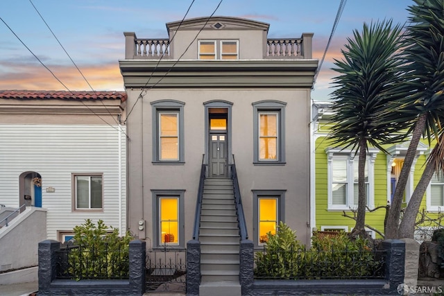 view of front of property with a fenced front yard and stucco siding