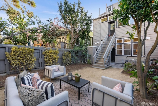 view of patio featuring a fenced backyard, stairway, and an outdoor hangout area