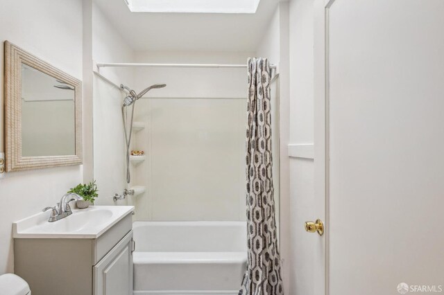 bathroom featuring shower / bath combination with curtain, vanity, and toilet