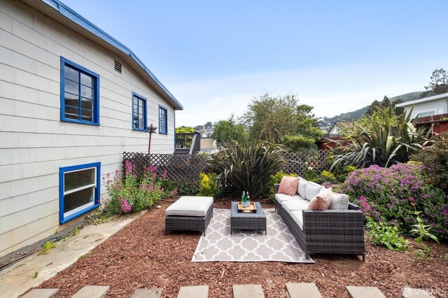 view of patio with outdoor lounge area and fence