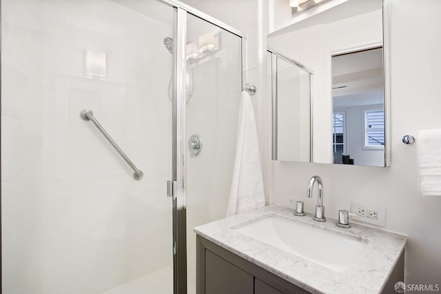 bathroom featuring an enclosed shower and vanity