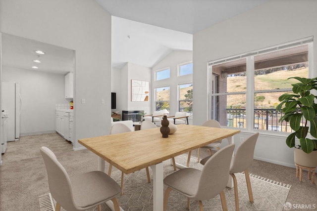 163 Stoneridge Ln, San Francisco, CA 94134 - dining room featuring light carpet, baseboards, and high vaulted ceiling