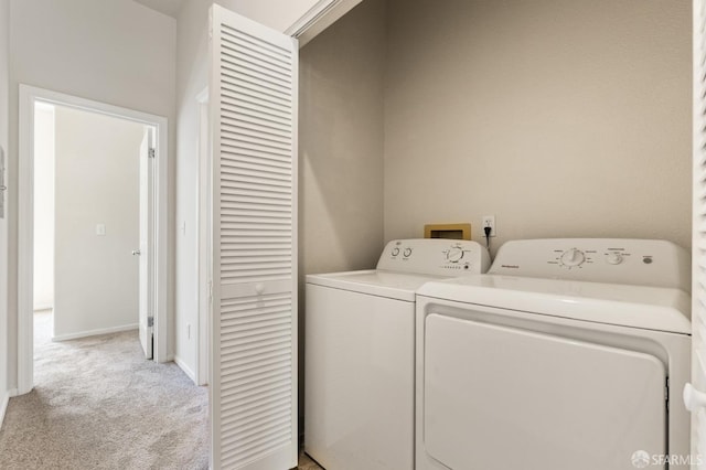 163 Stoneridge Ln, San Francisco, CA 94134 - clothes washing area featuring washing machine and clothes dryer, light carpet, and baseboards