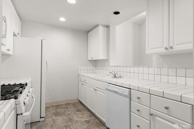 163 Stoneridge Ln, San Francisco, CA 94134 - kitchen with white appliances, white cabinets, recessed lighting, baseboards, and a sink