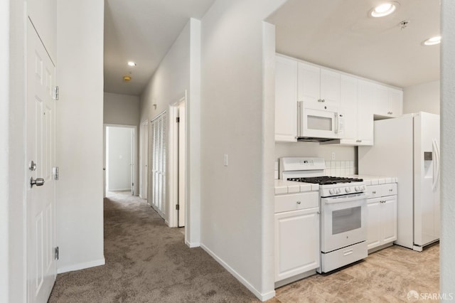 163 Stoneridge Ln, San Francisco, CA 94134 - kitchen featuring white appliances, tile counters, white cabinetry, light colored carpet, and recessed lighting