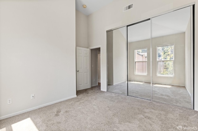 163 Stoneridge Ln, San Francisco, CA 94134 - unfurnished bedroom with carpet floors, baseboards, a closet, and a towering ceiling