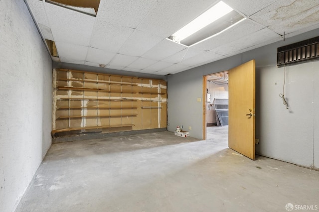 basement with a paneled ceiling