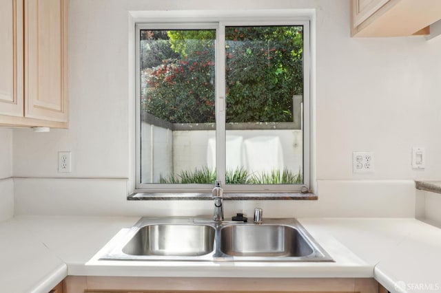 kitchen with light brown cabinetry and sink