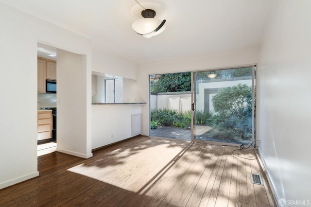 interior space featuring a healthy amount of sunlight and dark hardwood / wood-style flooring