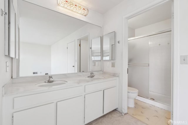 bathroom featuring vanity, an enclosed shower, and toilet