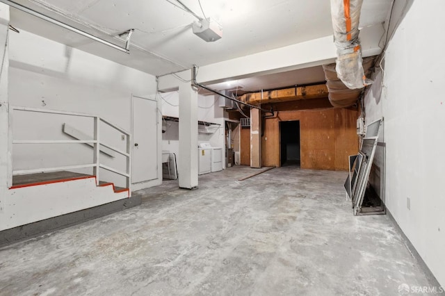 garage featuring washing machine and clothes dryer and a garage door opener