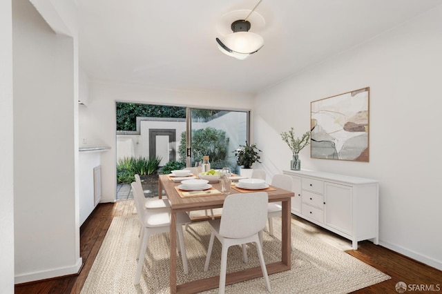 dining space featuring dark wood-type flooring