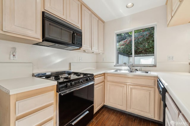 kitchen with dark hardwood / wood-style flooring, light brown cabinetry, sink, and black appliances