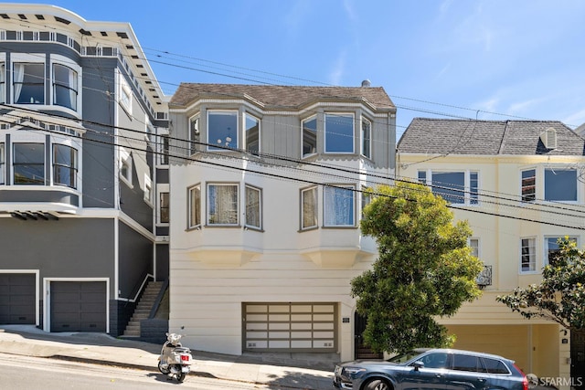 1347 Green St, San Francisco, CA 94109 - view of front of home with an attached garage and stucco siding
