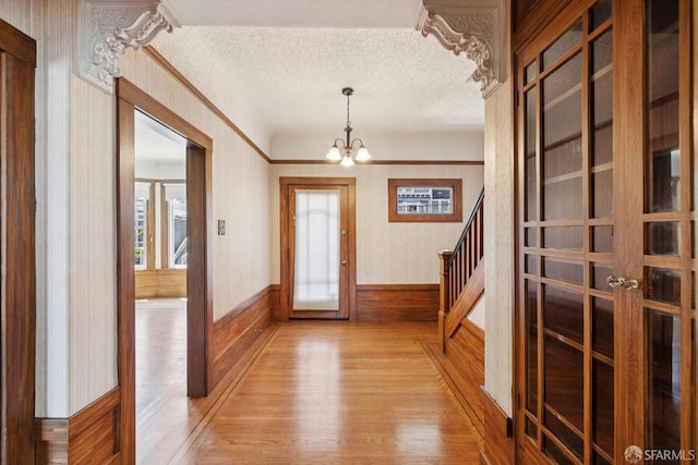 570 Jersey St, San Francisco, CA 94114 - entrance foyer featuring light wood-style flooring, a chandelier, a textured ceiling, plenty of natural light, and stairway