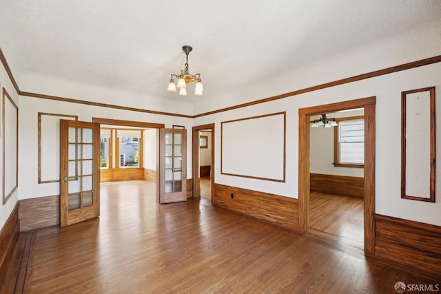 570 Jersey St, San Francisco, CA 94114 - empty room with a chandelier, french doors, wood finished floors, a wainscoted wall, and plenty of natural light