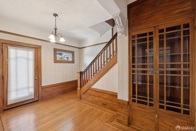 570 Jersey St, San Francisco, CA 94114 - foyer entrance featuring stairs, a chandelier, a textured ceiling, and wood finished floors