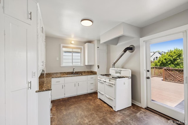 570 Jersey St, San Francisco, CA 94114 - kitchen with double oven range, plenty of natural light, white cabinetry, and dark stone counters