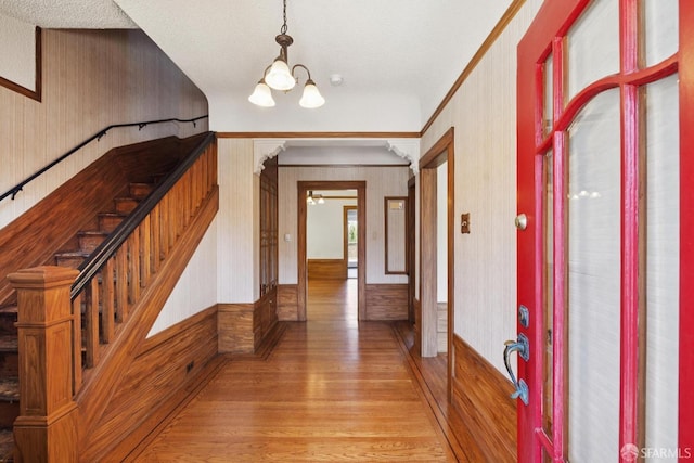 570 Jersey St, San Francisco, CA 94114 - entrance foyer featuring light wood-style flooring, wallpapered walls, a chandelier, stairway, and ceiling fan