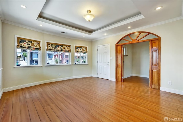 2486 26th Ave, Oakland, CA 94601 - spare room featuring a tray ceiling, arched walkways, light wood-type flooring, recessed lighting, and ornamental molding