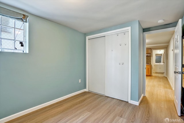 2486 26th Ave, Oakland, CA 94601 - unfurnished bedroom with light wood finished floors and a closet