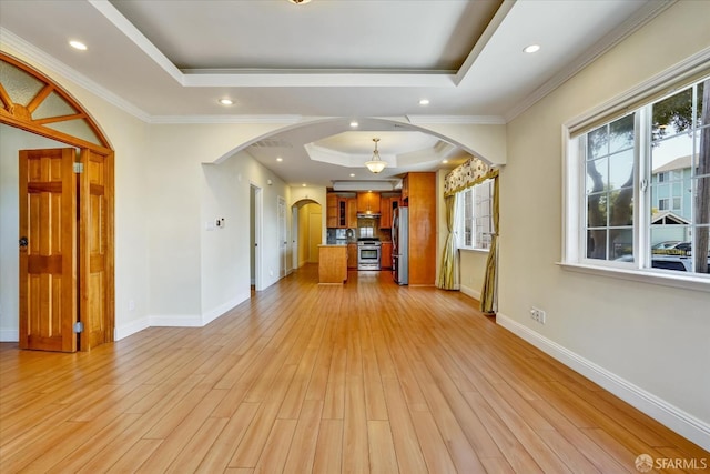 2486 26th Ave, Oakland, CA 94601 - unfurnished living room with a raised ceiling, arched walkways, light wood-style floors, recessed lighting, and crown molding