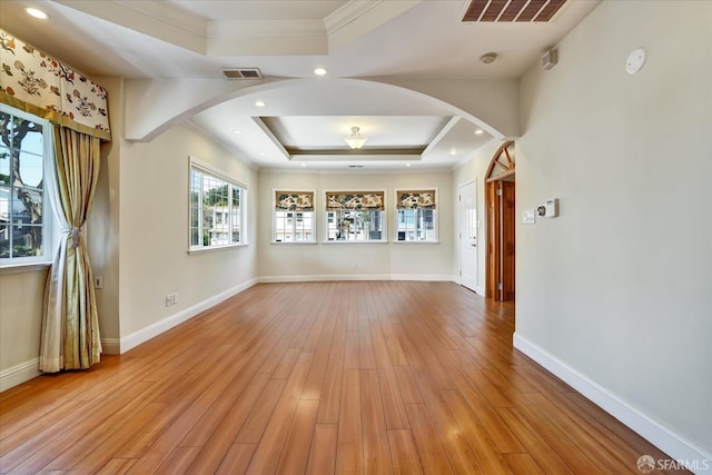 2486 26th Ave, Oakland, CA 94601 - spare room featuring arched walkways, a raised ceiling, ornamental molding, and light wood finished floors