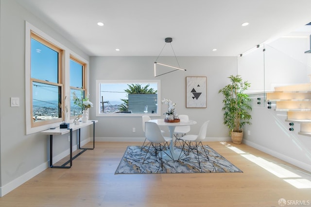 dining space with light hardwood / wood-style floors