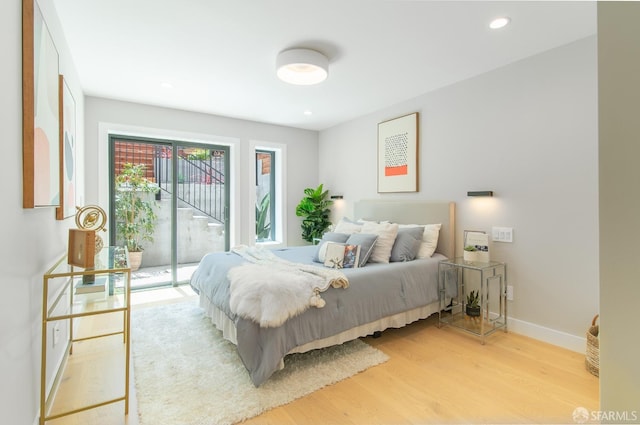 bedroom featuring access to outside and light hardwood / wood-style floors