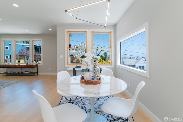 dining space with light hardwood / wood-style floors