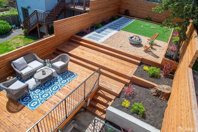 balcony featuring an outdoor living space with a fire pit