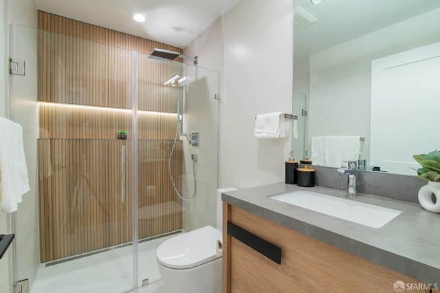 bathroom featuring vanity, toilet, and walk in shower