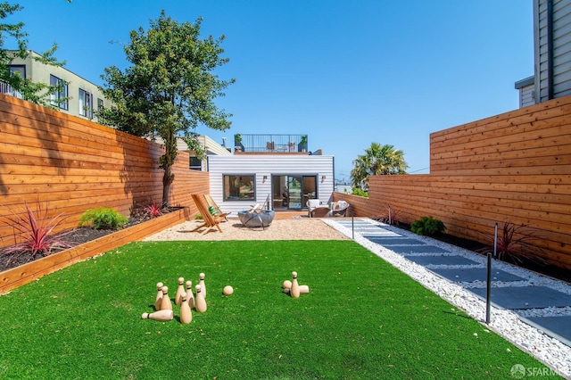 view of yard with a patio and an outdoor fire pit