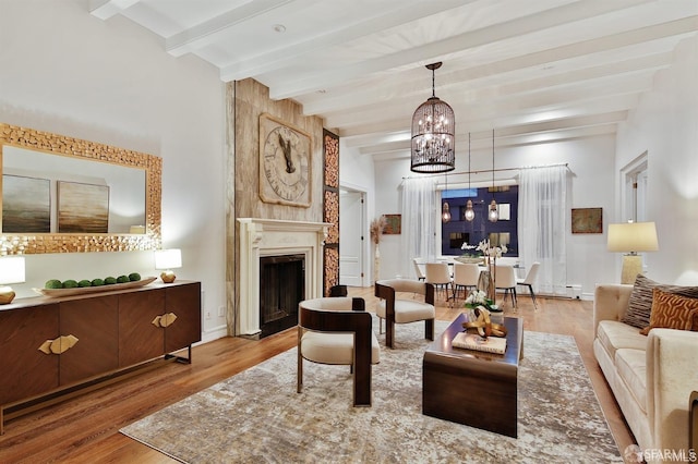850 Powell St Unit 104, San Francisco, CA 94108 - living room featuring a chandelier, beamed ceiling, wood finished floors, and a fireplace with flush hearth