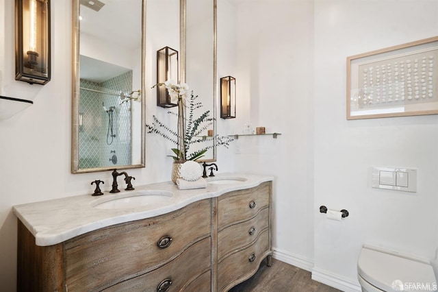 850 Powell St Unit 104, San Francisco, CA 94108 - full bathroom with toilet, wood finished floors, a shower, double vanity, and baseboards