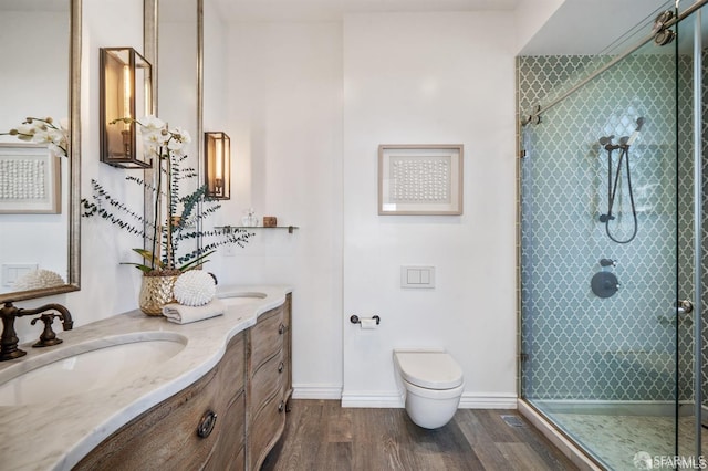 850 Powell St Unit 104, San Francisco, CA 94108 - bathroom featuring toilet, a shower stall, wood finished floors, double vanity, and baseboards