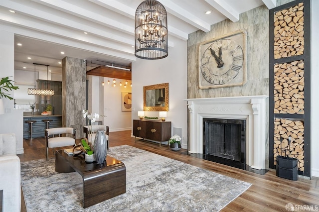 850 Powell St Unit 104, San Francisco, CA 94108 - living room featuring wood finished floors, baseboards, beamed ceiling, a chandelier, and a fireplace with flush hearth
