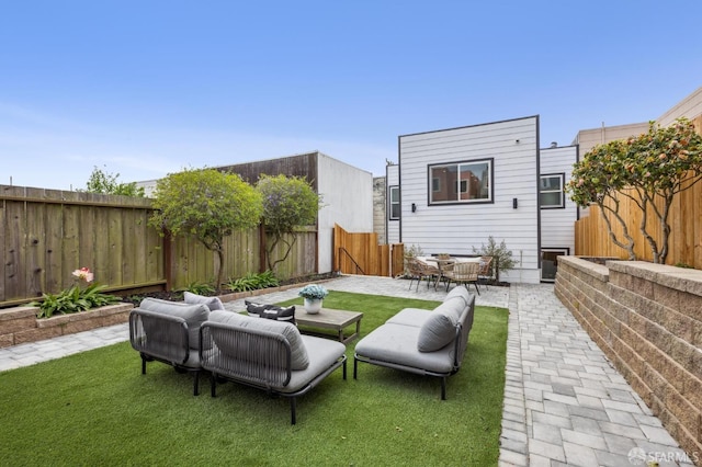back of house featuring a patio and outdoor lounge area