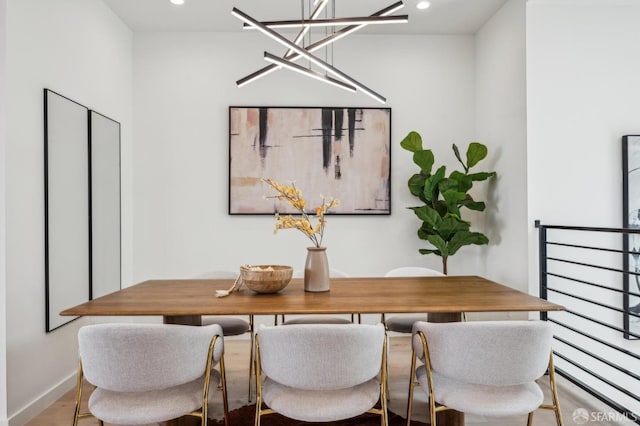dining space with a chandelier, recessed lighting, and baseboards